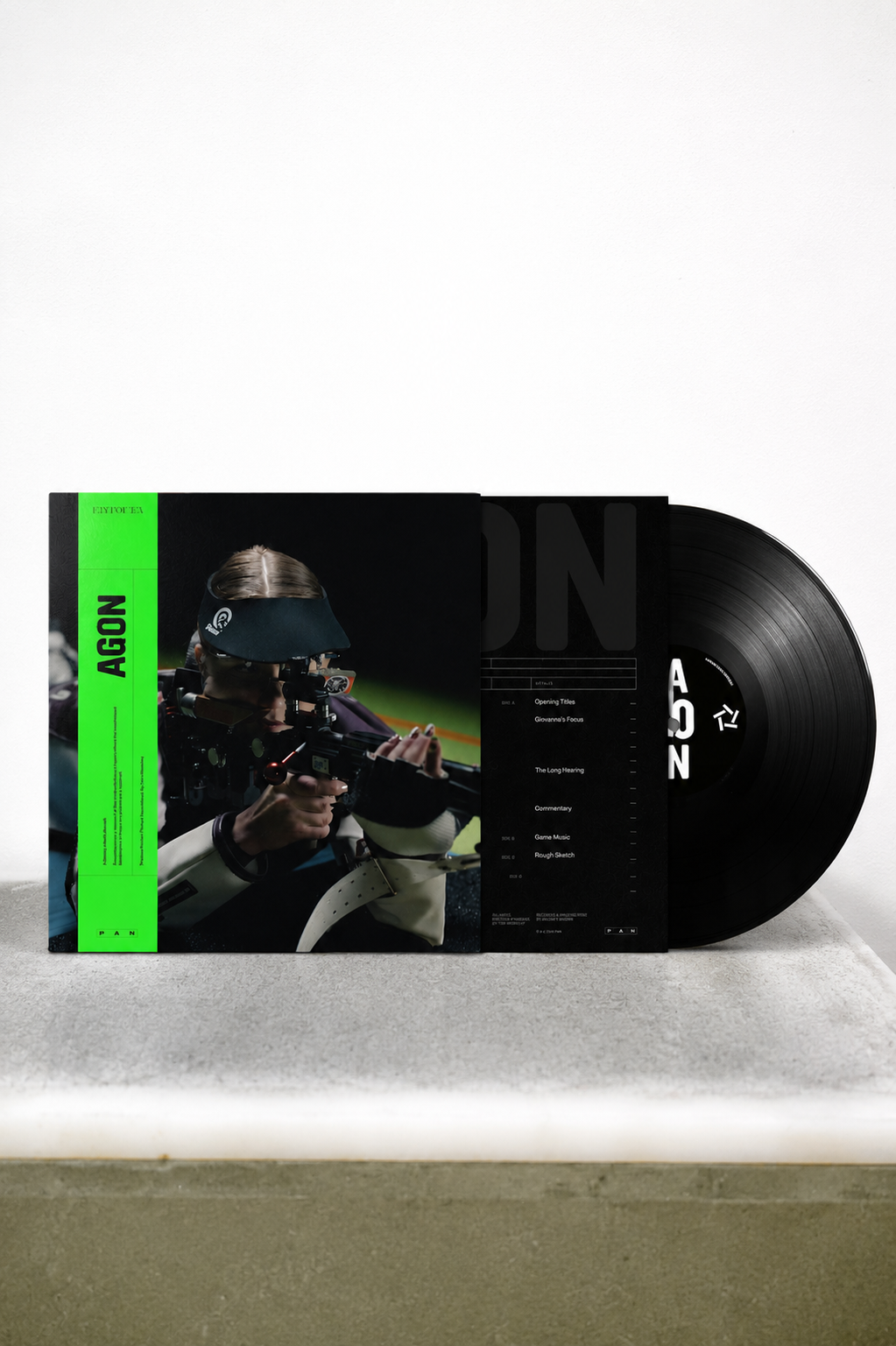Vinyl record partially pulled from its sleeve, showing the album cover art and black record on a light gray surface against a white background.