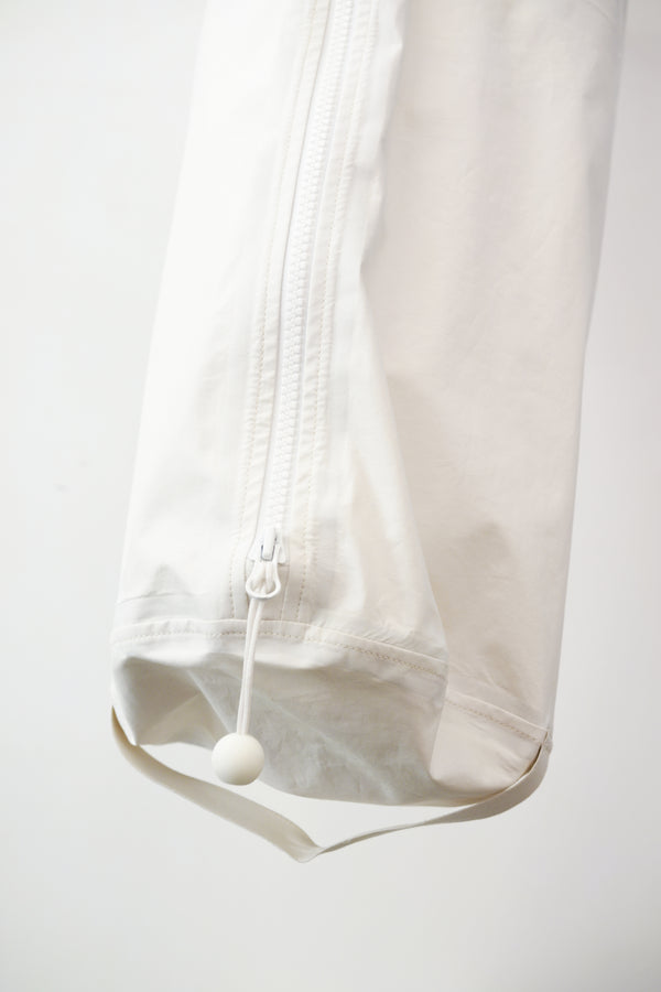 white kit bag detail, against a plain white wall.