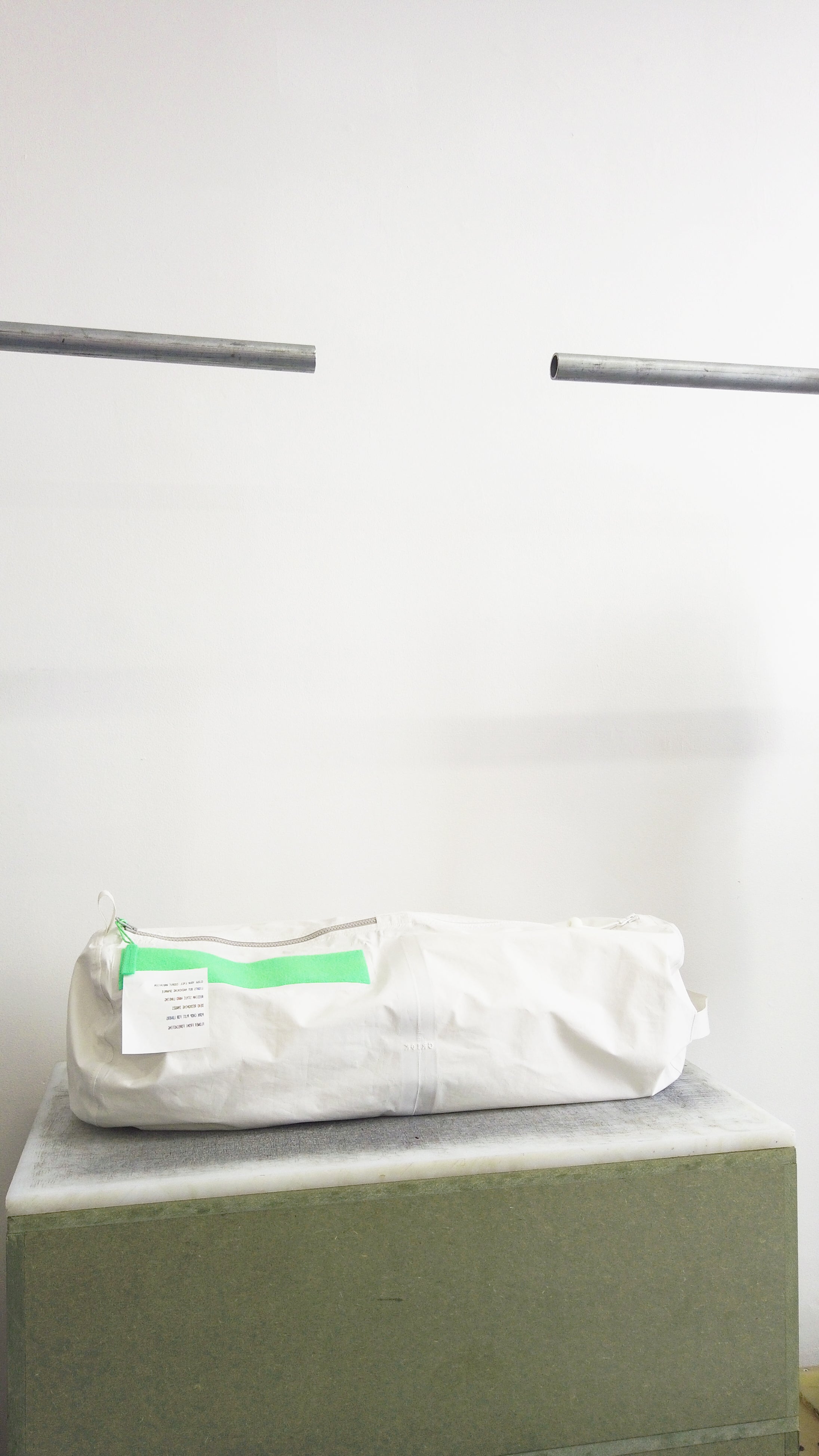 White kit bag against plain white wall